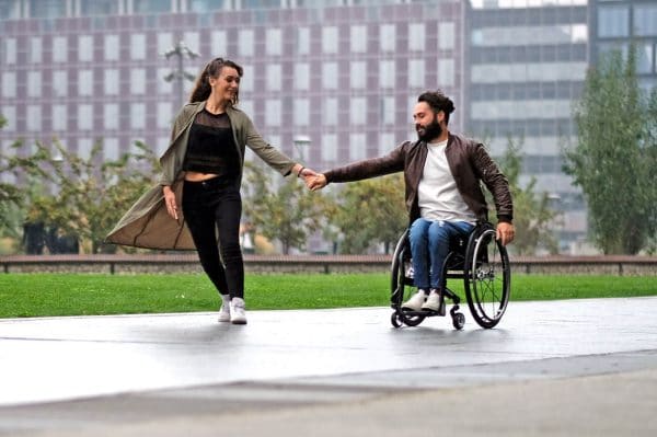 Stylish Man With Lady on Quickie Nitrum Wheelchair